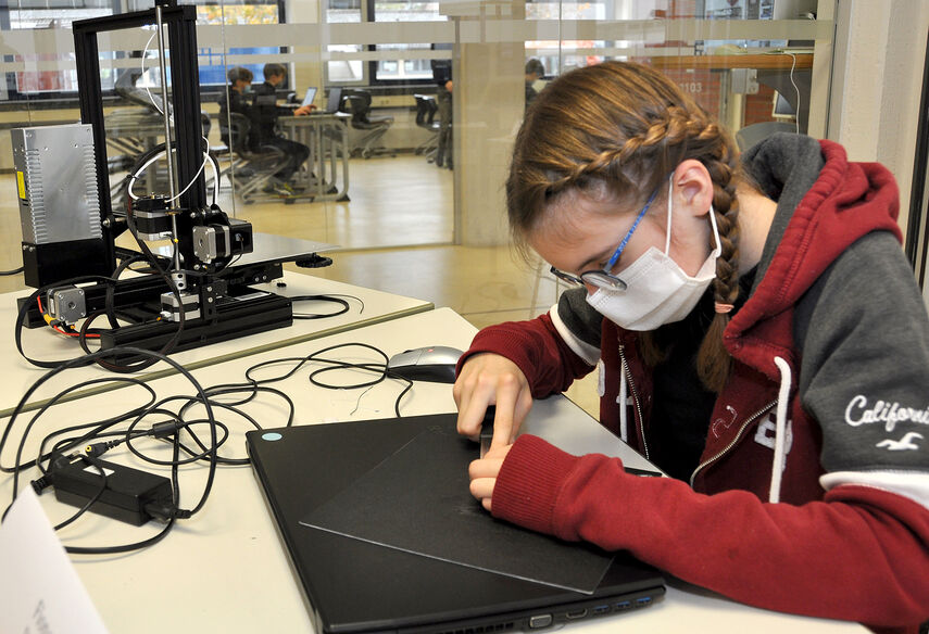 Eine Schüler arbeitet an einem 3D Drucker an einem Prototyp
.